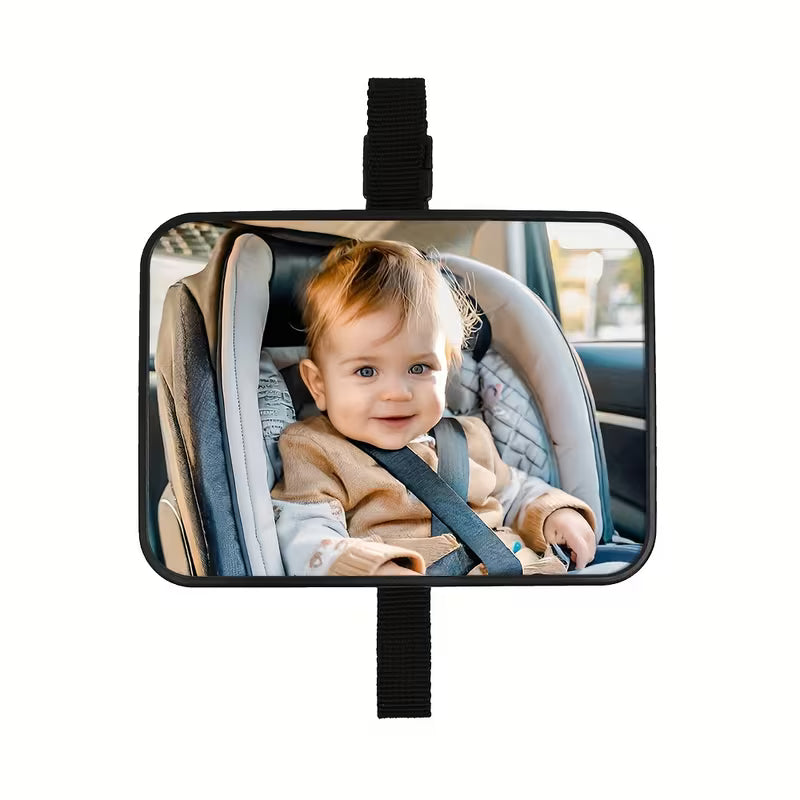 Baby in a car seat with a rearview mirror showing the baby's reflection